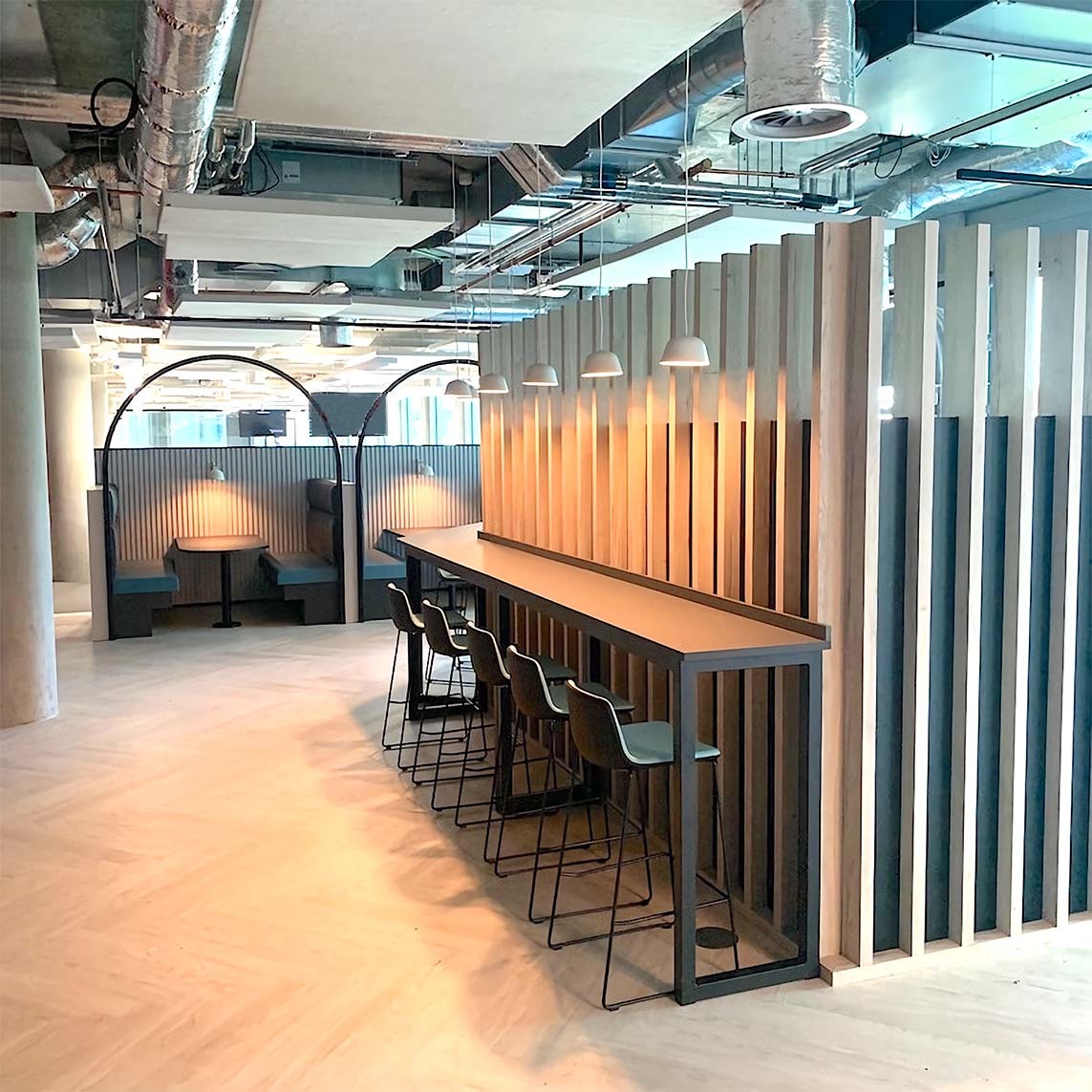 Wooden workbench and timber partition wall manufactured by Gralyn Joinery for the Spinningfields office fit-out