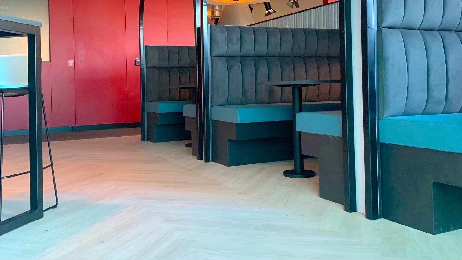 Bespoke seating booths designed by Gralyn Joinery featuring architectural metal hoops